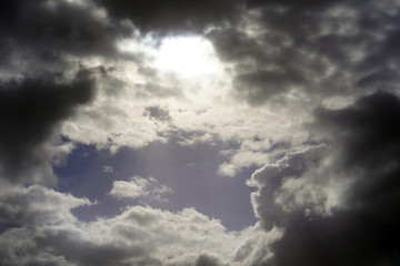 Black rain clouds in the rays of the sun in the sky. Dark clouds the sky.