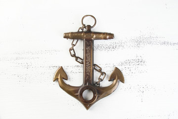 Vintage brass anchor wooden background © voisine574