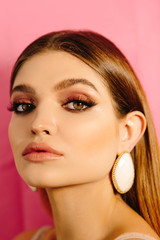 Fototapeta premium Stylish retro portrait of a beautiful girl with make-up, accessories and big eyes and lips