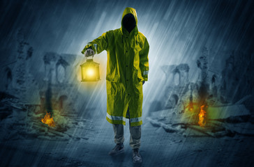 Destroyed place after a catastrophe with man in raincoat and lantern concept
