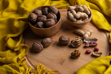 Walnuts kernels on dark desk with color background, Whole walnut in wood vintage bowl, Nuts in bamboo wooden bowl, walnuts in wood bamboo bowl