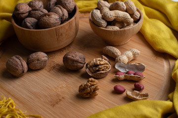 Walnuts kernels on dark desk with color background, Whole walnut in wood vintage bowl, Nuts in bamboo wooden bowl, walnuts in wood bamboo bowl