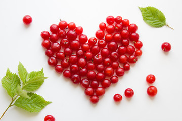 Heart made from cherries isolated on white. Love concept. Top view, flat lay.