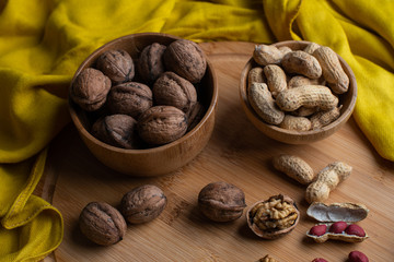Walnuts kernels on dark desk with color background, Whole walnut in wood vintage bowl, Nuts in bamboo wooden bowl, walnuts in wood bamboo bowl