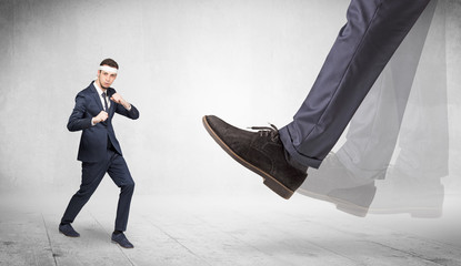 Big foot trample young suited karate man
