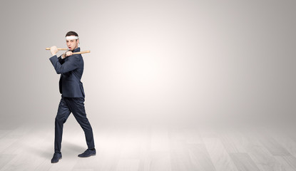 Obraz premium Young businessman in suit fighting in an empty space 