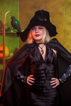 Photo of smiling witch in black hat, dress