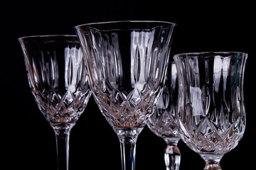 Group of finely chiseled alcohool glasses, close up with black background