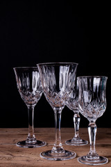 Group of finely chiseled alcohool glasses, close up with black background