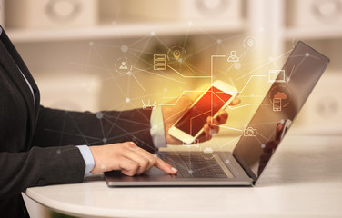 Business woman in homey environment using laptop with  online storage and cloud technology concept
