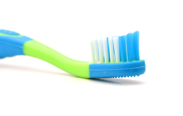 Close up of a blue toothbrush over white background