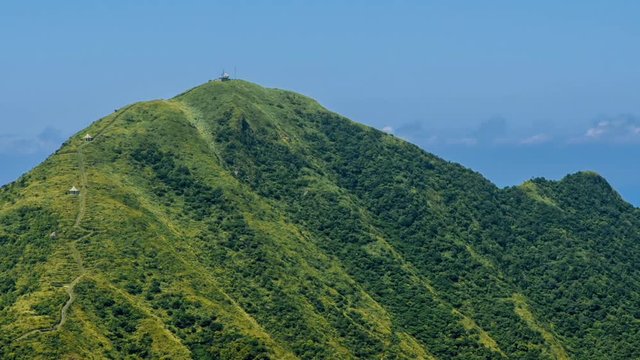 Timelapse of Keelung mountain with blue sky in New Taipei city. Beauty Hyperlapse of landscape of green mountains with long stairs and chinese pavilion. Scenic of a beautiful summer day in Jishan-Dan