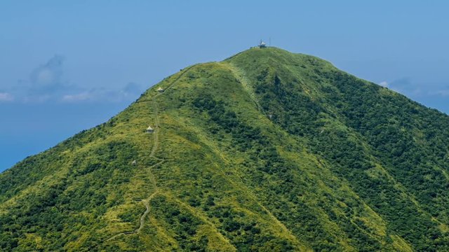 Timelapse of Keelung mountain with blue sky in New Taipei city. Beauty Hyperlapse of landscape of green mountains with long stairs and chinese pavilion. Scenic of a beautiful summer day in Jishan-Dan