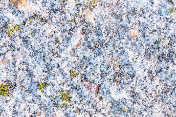 First light snow at the beginning of winter on surface of a gravel path. Symbol of the coming winter. Natural background texture