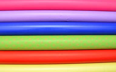 Rolls of colorful wrapping paper on white background