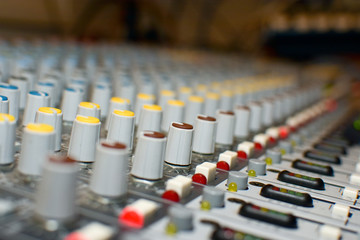 Close up shot of buttons, dials and controls of sound board