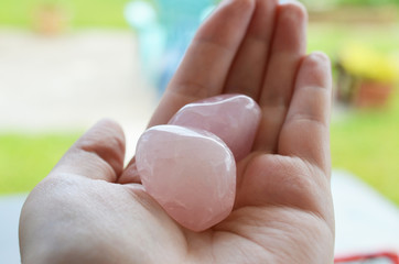 Beautiful, bright tumbled crystal chips. Stunning healing crystals. Macro photograph, low exposure. Hand holding crystals, bright healing crystals. Crisp colors and lighting, clear quartz, opalite
