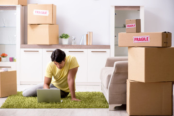 Fototapeta premium Man moving house and relocating with fragile items