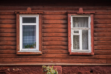Modern plastic window next to the old wooden frame
