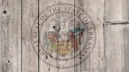 USA Politics News Concept: US State Arkansas Seal Wooden Fence Background