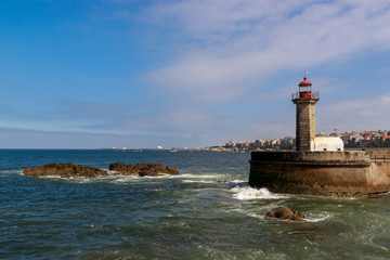 Fototapeta premium Lighthouse in Foz do Douro at the mouth of the river Douro in Porto, Portugal. Atlantic ocean. Travel photography.