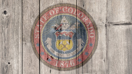 USA Politics News Concept: US State Colorado Seal Wooden Fence Background