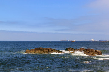 Fototapeta na wymiar Rocks in the Atlantic ocean, Porto, Portugal. Beautiful coast on a Sunny day.