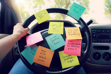Steering wheel covered in notes as a reminder of errands to do