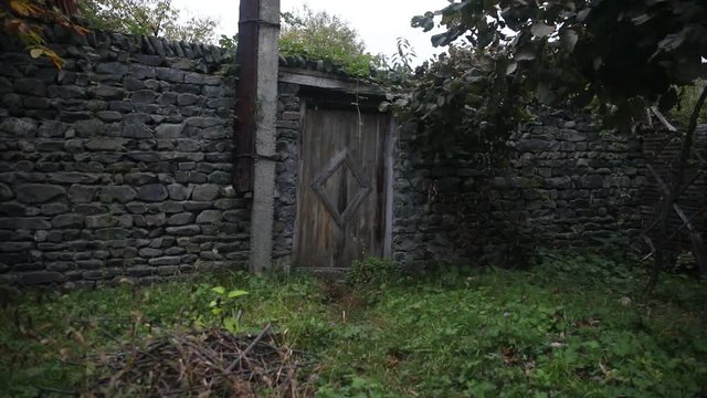 Wooden door of an old stone building. brown wooden, double door with white stone wall edging.