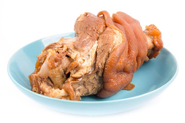 Stewed pork leg in blue  bowl isolated on white background
