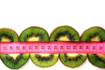 Fruit for weight loss, Meter - a device for measuring length, a healthy lifestyle, kiwi, isolated on white background