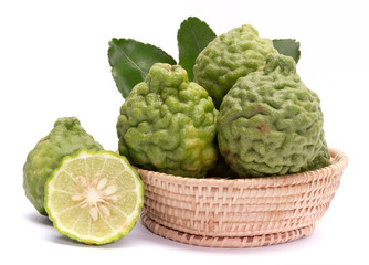 The kaffir lime leaves in the basket on a white background.