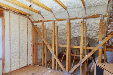 New home construction with installation of attic with foam insulation