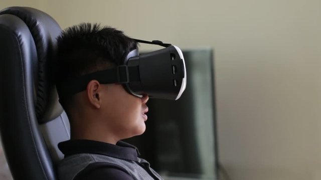 Young boy wearing virtual reality headset on digital screen. Vr is interactive computer-generated experience taking place within simulated environment. Visual future technology concept.