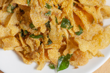 close up of salted egg potato chips on plate