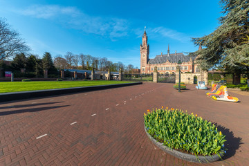 THE HAGUE, 31 August 2018 - Sunrise at the Peace Palace, seat of the International Court of Justice, view from the peaceful entrance with the tulips flowers blooming