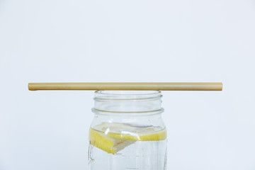 Lemon water and bamboo drinking straw.