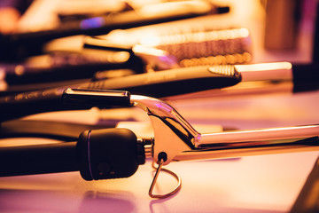Hairstyle hot electric tools on hairstylist table ready to use