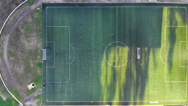 Professional football players training field aerial view. Football team training stadium drone flight. Sunset soccer stadium view. - Powered by Adobe