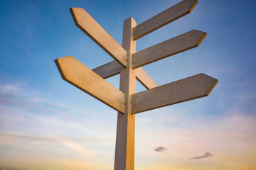 Wooden Guide Post on Sunset Sky background