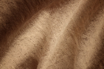 Naklejka premium Background of natural brown cloth dark of the edges.