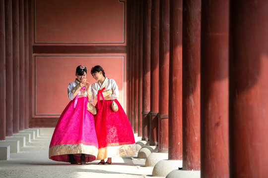 Korean lady in Hanbok or Korea gress and walk in an ancient town