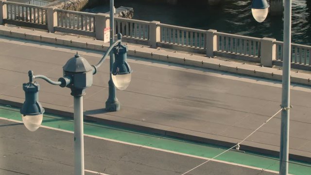 Pedestrians and Car Traffic zoom along the San Francisco Bay Trail  Boardwalk