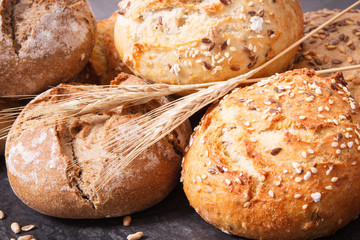 Wholegrain rolls or bread with seeds and ears of rye grain