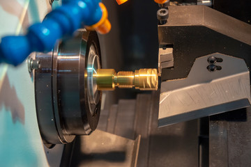 The CNC lathe or turning machine cutting the thread  at the metal  shaft.Hi-technology manufacturing process.