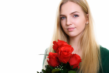 Close up of young beautiful teenage girl holding red roses ready