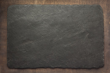slate stone at wooden background