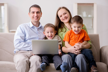 Young family surfing internet and looking at photos