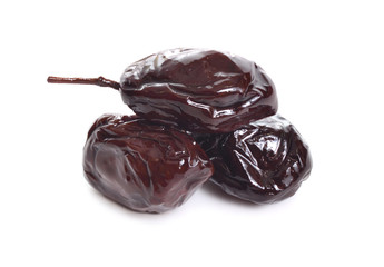 Three Sun-dried olives isolated on white background