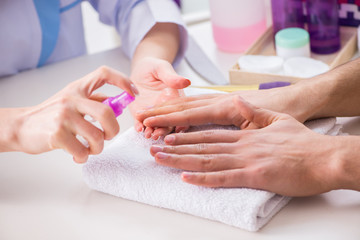 Obraz na płótnie Canvas Hands during manicure care session